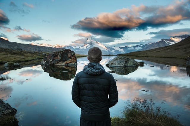 man looking at reflection sky