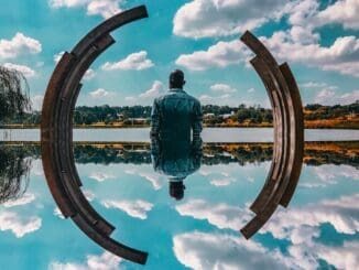 man looking reflectively at sky thinking about IFS for internalized homophobia