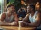 Two people in genuine conversation at Chicago cafe, illustrating authentic connection in LGBTQ+ therapy