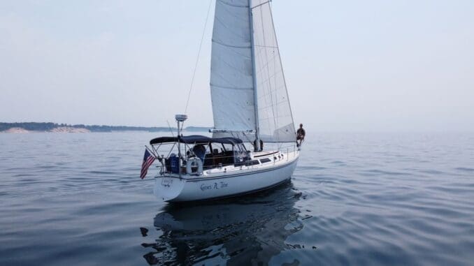 successful man on sailboat lake michigan